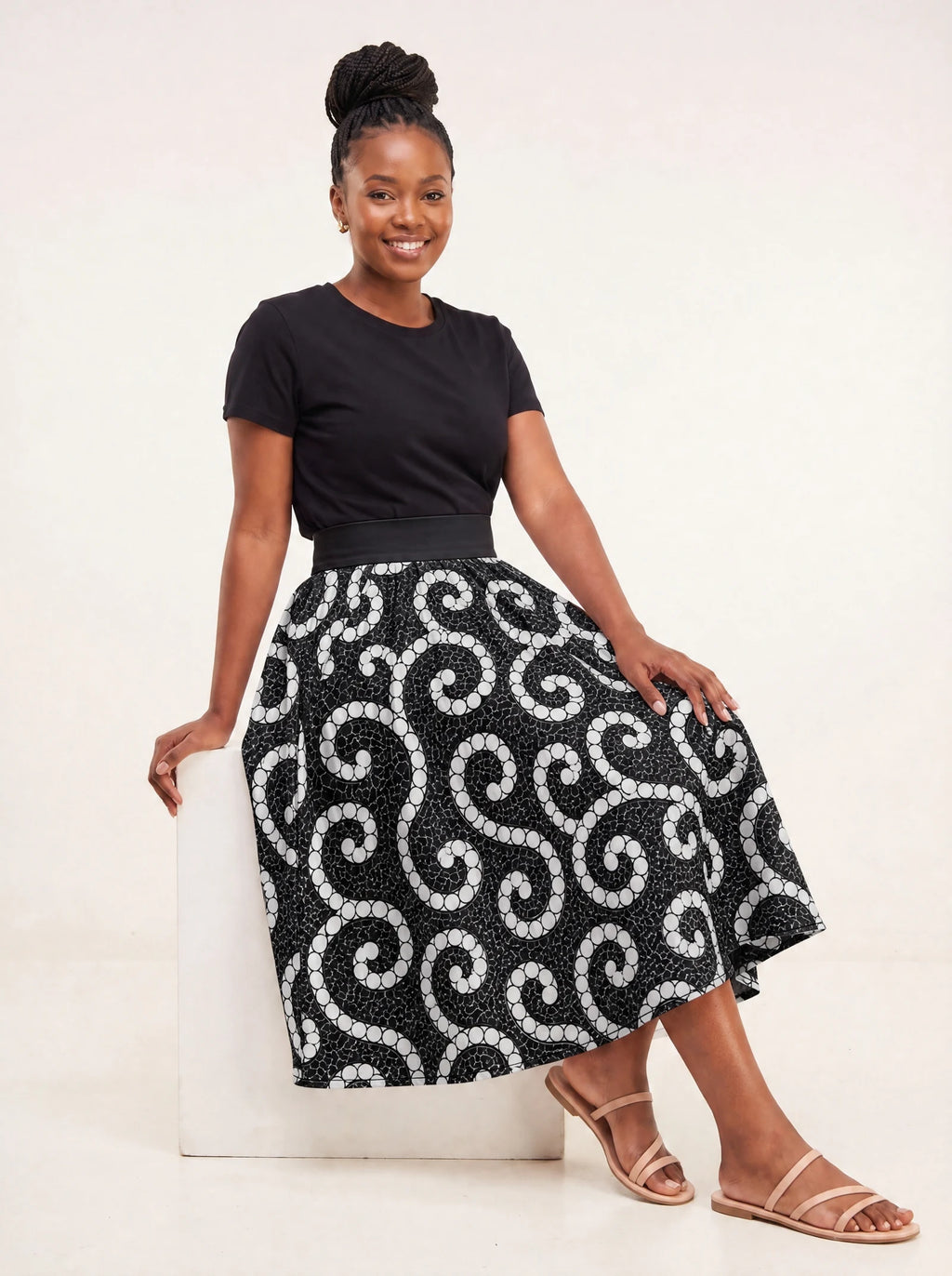 "Duara" Twirl Skirt — seated on a studio cube