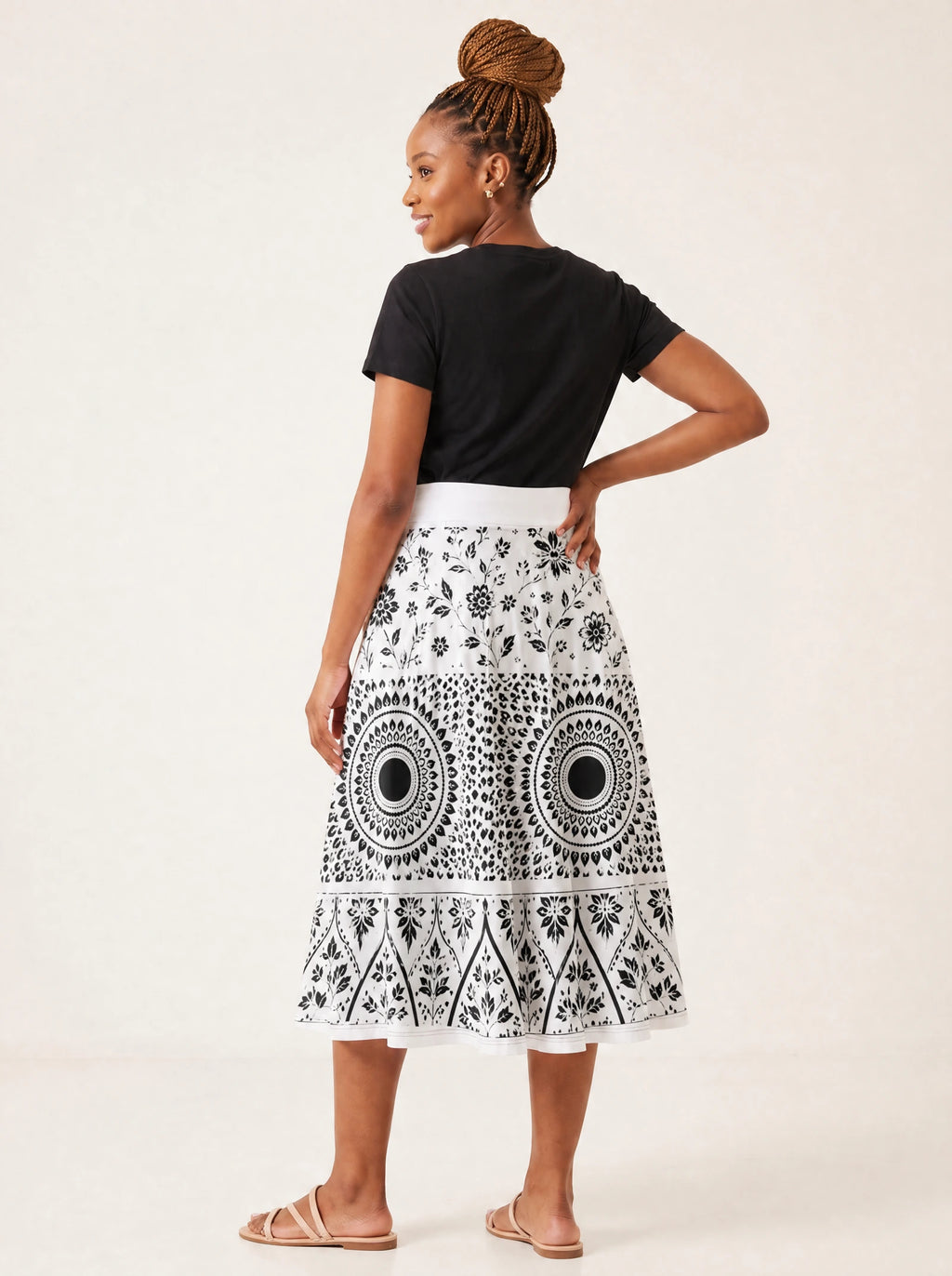 "Mwanga" Twirl Skirt — back three-quarter view, looking over shoulder