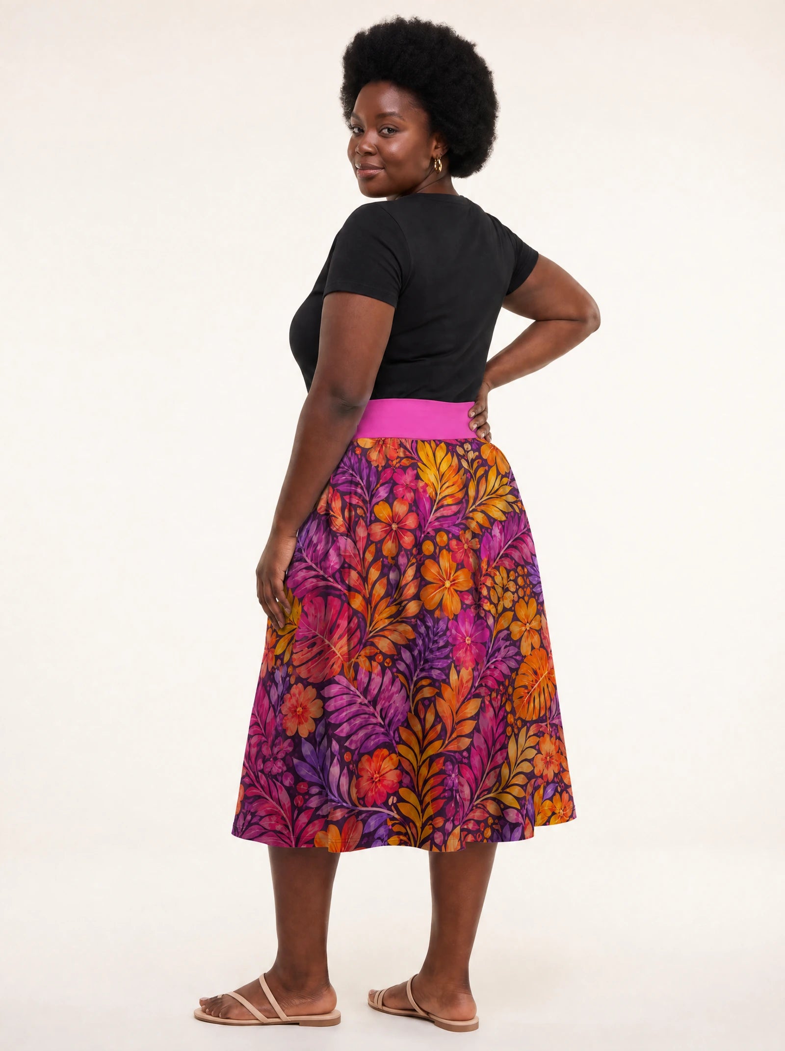 "Waridi" Twirl Skirt — back three-quarter view, looking over shoulder