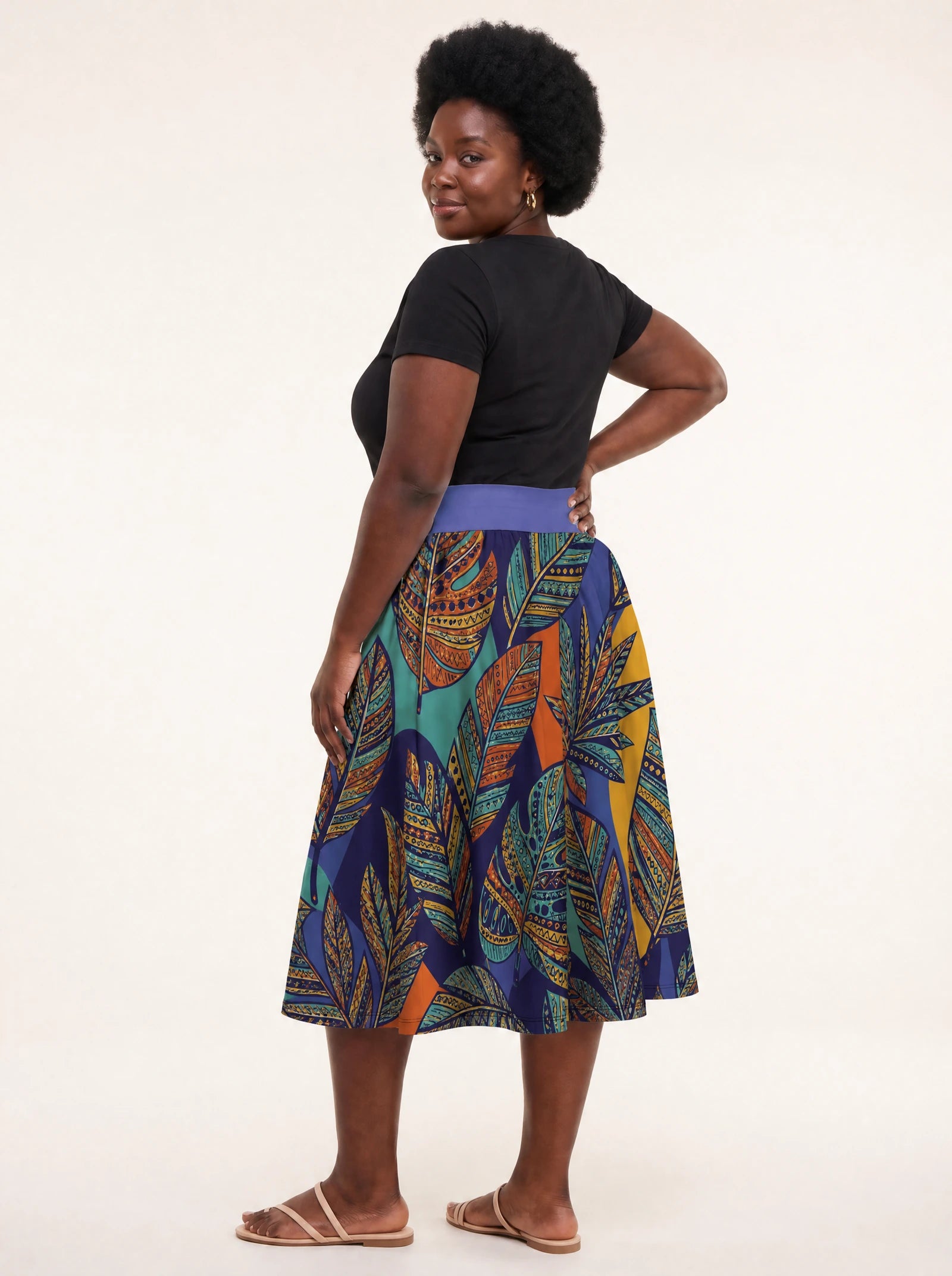 "Majani" Twirl Skirt — back three-quarter view, looking over shoulder