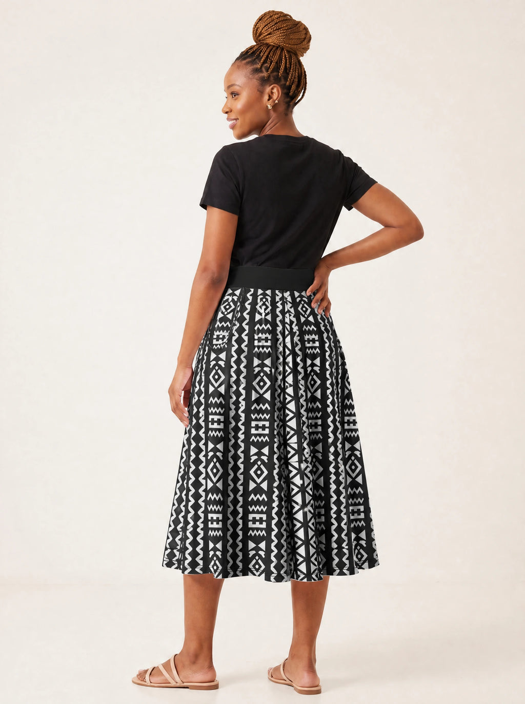 "Kuba" Twirl Skirt — back three-quarter view, looking over shoulder