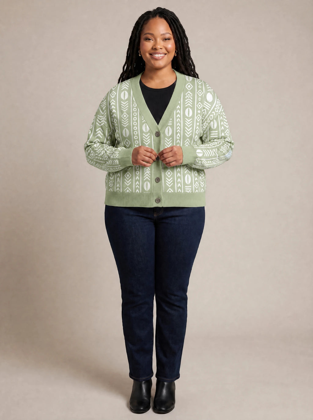"Oshun Verde" Cardigan — on model fastening the buttons