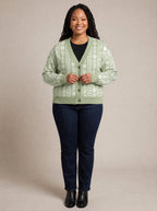 "Oshun Verde" Cardigan — on model fastening the buttons