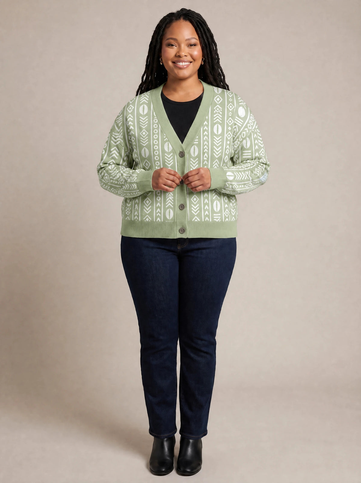 "Oshun Verde" Cardigan — on model fastening the buttons