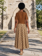 "Kahawa" Short Sleeve Maxi Dress — back view on model in the churchyard