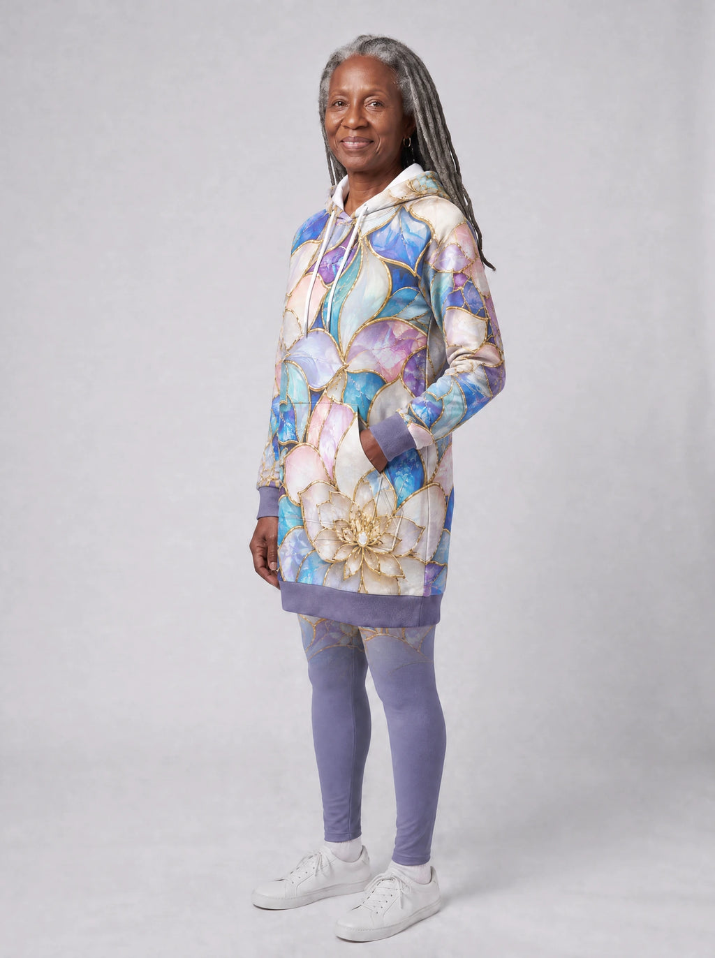 "Kioo" Hoodie Dress — three-quarter view on model, hand in pocket, styled with the matching leggings