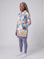 "Kioo" Hoodie Dress — three-quarter view on model, hand in pocket, styled with the matching leggings