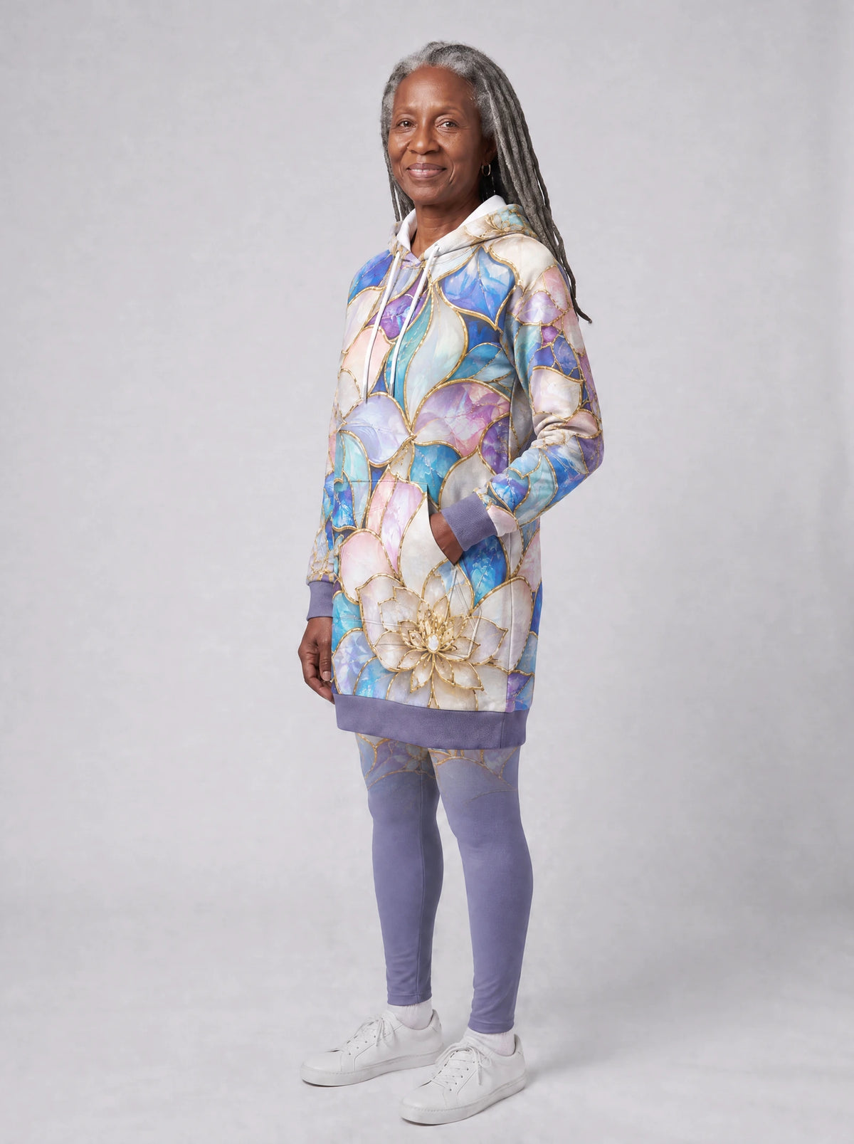 "Kioo" Hoodie Dress — three-quarter view on model, hand in pocket, styled with the matching leggings