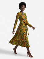 "Kumasi" Long Sleeve Midaxi Dress — three-quarter view on model, hand in the side pocket