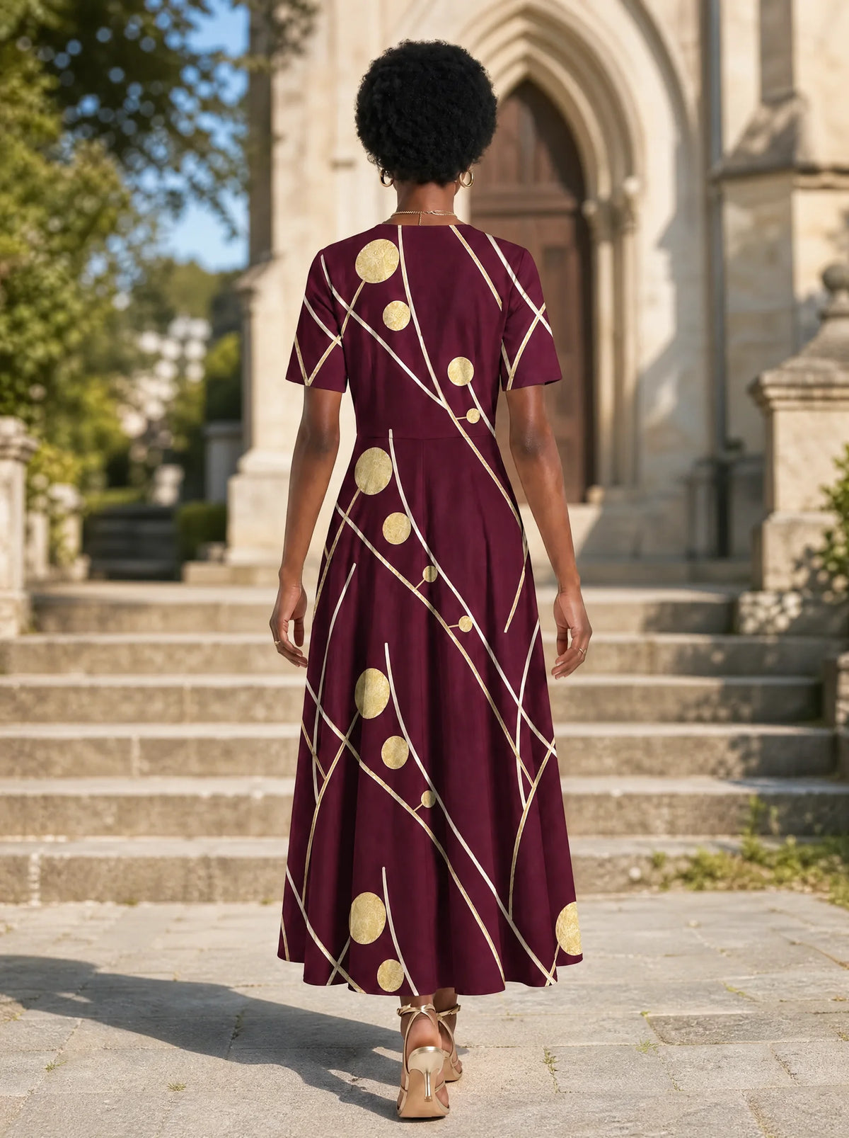 "Mvinyo" Short Sleeve Maxi Dress — back view on model in the churchyard