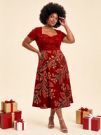 "Mzeituni" Red Sweetheart Midi Dress — on model, Christmas backdrop