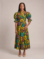 "Njano" Puff Sleeve Dress — standing, angled view on model