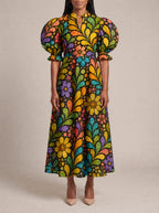 "Njano" Puff Sleeve Dress — three-quarter view on model