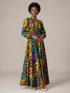 "Njano" Puff Sleeve Maxi Dress — standing, angled view on model
