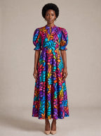 "Rangi" Puff Sleeve Dress — standing, angled view on model