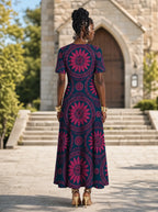 "Tausi" Short Sleeve Maxi Dress — back view on model in the churchyard