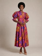 "Waridi" Puff Sleeve Dress — walking, three-quarter view on model