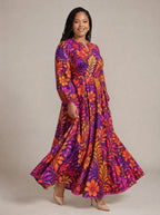 "Waridi" Puff Sleeve Maxi Dress — walking, three-quarter view on model