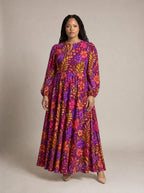 "Waridi" Puff Sleeve Maxi Dress — standing, angled view on model