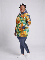 "Zafarani" Hoodie Dress — three-quarter view, hand in pocket on model, styled with the matching leggings