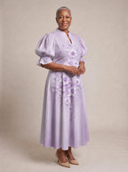 "Zambarau" Puff Sleeve Dress — walking, three-quarter view on model