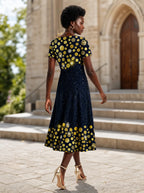"Zawadi" Sweetheart Midi Dress — back view on model in the churchyard